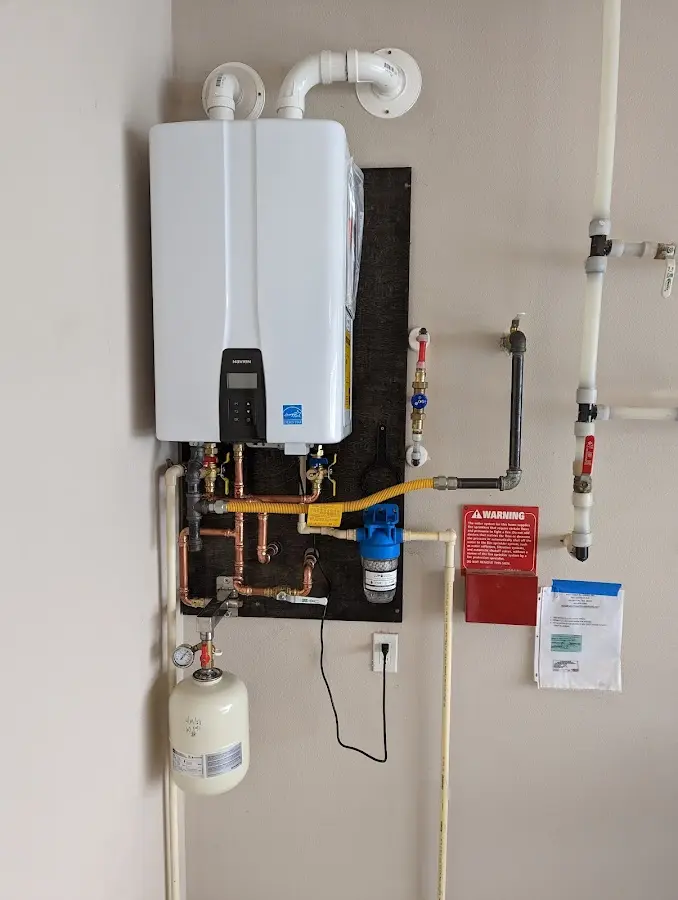 Professional plumber installing copper piping in a Holmes Beach home